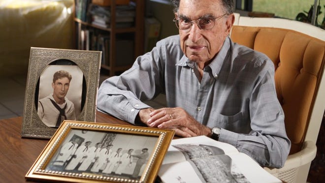 Ferdinando D’Alauro, 88, showing WWII mementos in his Palm Beach Shores home, was at Hawaii’s Kaneohe Naval Air Station on Dec. 7, 1941. Japan bombed it just before hitting Pearl Harbor.