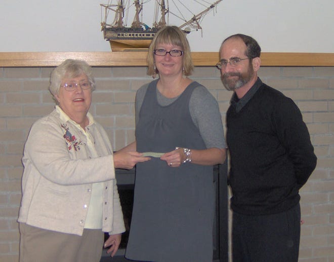 Quota Club of Bath Board Member, Mary Kay Quiggle (left) presents a donation to Southeast Steuben County Library Director, Pauline Emery (center), and Assistant Director Brad Turner (right), for the Corning Library Hearing Loop Project.