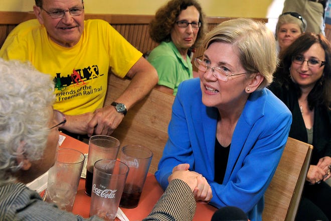 Democratic front-runner Elizabeth Warren, right, talks with supporters at the J & M Diner in Framingham during her first day of campaigning.