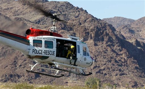 A Las Vegas Metropolitan Police rescue helicopter lift off carrying a scout team to the site of a tour helicopter crash to search for access to begin the recovery process, Thursday, Dec. 8, 2011, in Las Vegas. Five people died when a helicopter on a tour of the Las Vegas Strip and Hoover Dam crashed in a remote site near Lake Mead on Tuesday night killing the pilot and four passengers.