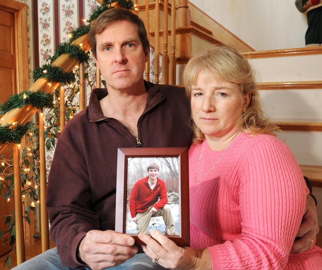Brian Cooney and his wife, Suzanne, of Bridgewater hold a photograph of their son Jeffrey on Thursday, December 08, 2011.