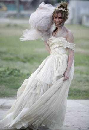 In this Dec. 5, 2010 file photo, an actress dressed as a zombie bride looks on during the filming of the movie 'Juan de los Muertos, or, 'Juan of the Dead' in Havana, Cuba. Screenings of the film by writer-director Alejandro Brugues started the week of Dec. 8, 2011 in Havana. (AP Photo/Javier Galeano, File)