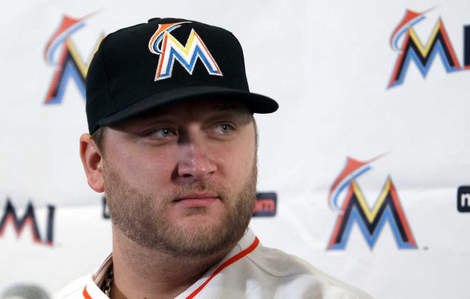 The Marlins' Mark Buehrle looks on after after he was introduced during a news conference on Friday in Miami. The left-hander Buehrle signed a $58 million, four-year contract with the club.