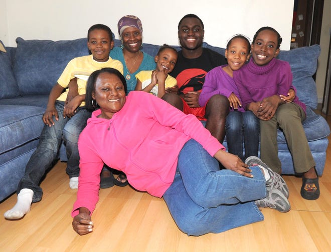 Nadia Gay, front, relaxes with her extended family, from left, Nathaniel Salomon, 9; Jude Salomon, 36; Elsa Salomon, 5; Phillip Gay, 18; Lizabeth Salomon, 10; and Fabiola Salomon, 11.