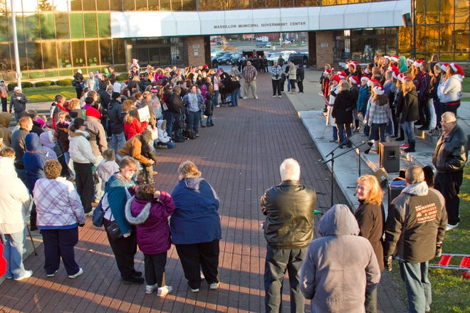 People gather in Duncan Plaza to sing and await the arrival of Santa through the help of the Washington High School Cheerleaders during the annual Holly Days event.