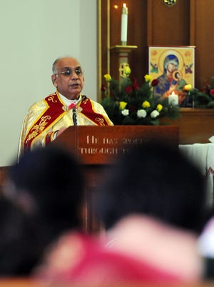 The Rev. Varghese Naikamparambil speaks to parishioners during a ceremony at St. Jeremiah's Church on Sunday morning.