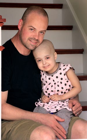 Charlotte Rose Kelly was 3 when this picture was taken of her with her father Greg Kelly in April 2010. Charlotte died Wednesday Dec. 7, 2011 at her home from a rare form of cancer.