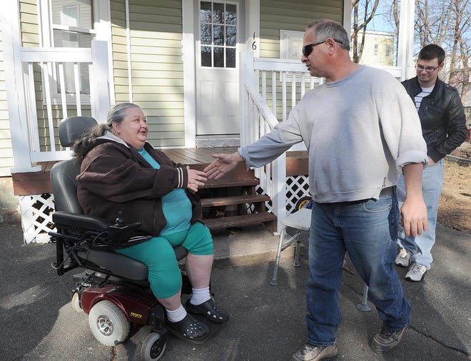 Christine Perry thanks Fred Napolitano of Baldwynville and his son, Ryan, for helping her get the new wheelchair.