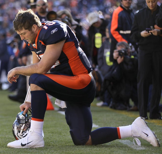 Denver Broncos quarterback Tim Tebow (15) prays in the end zone before the start of an NFL football game against the Chicago Bears, Sunday, Dec. 11, 2011, in Denver. (AP Photo/Julie Jacobson)
