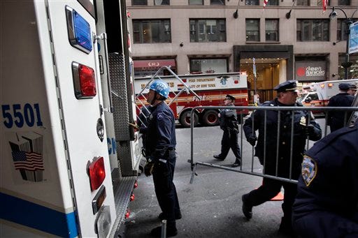 Emergency personnel gather outside of a building where there was an elevator accident in New York, Wednesday, Dec. 14, 2011. Suzanne Hart, a 1993 Knox College graduate, was killed when her foot or leg became caught in an elevator's closing doors, New York City fire officials said Wednesday. (AP Photo/Seth Wenig)