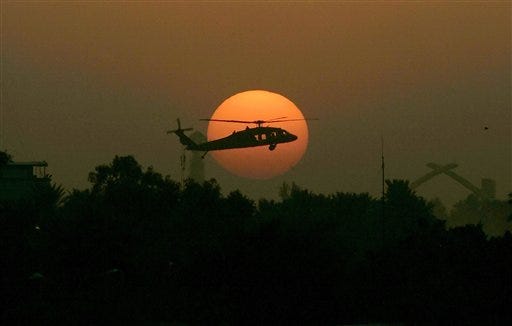 In this Tuesday, Oct 30, 2007 file photo, a U.S. army Black Hawk helicopter flies as the sun sets over Baghdad. In the beginning, it all looked simple: topple Saddam Hussein, destroy his purported weapons of mass destruction and lay the foundation for a pro-Western government in the heart of the Arab world. Nearly 4,500 American and more than 100,000 Iraqi lives later, the objective now is simply to get out _ and leave behind a country where democracy has at least a chance, where Iran does not dominate and where conditions may not be good but "good enough."