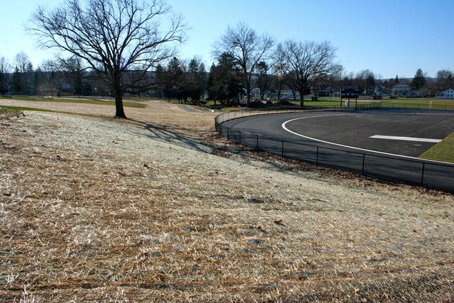 The new track and football field at Dundee Central School are complete and surrounded by a fence that shortens the area previously used by sledders.