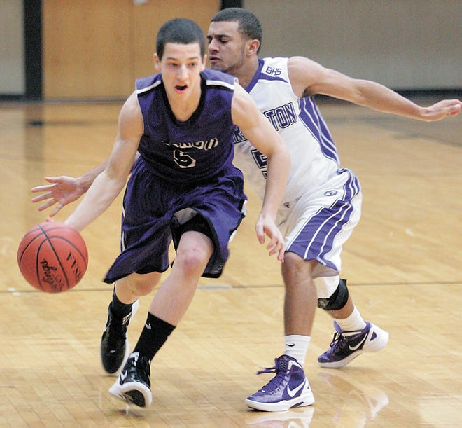 Jackson’s Kyle Mottice shoots around Barberton’s D.J. Phillips during a recent game. Mottice is a sophomore guard who has contributed to the Polar Bears’ 2-2 start off the bench.