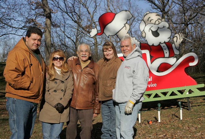 Festival of Lights committee members Doug Nietz (from left) Wendie Thorpe, Joe Marino, Julie Hendrickson and Ray Padron stand near one of the Sinnissippi Park displays Friday, Dec. 9, 2011, in Rockford.