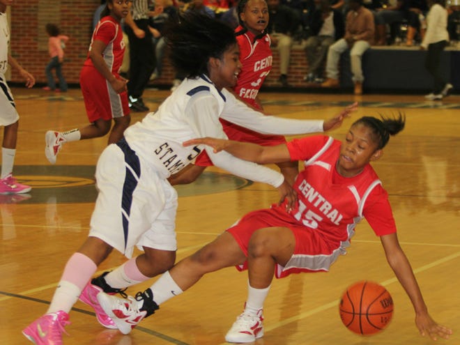 Paul W. Bryant High School’s Destinie Wilson, left, collides with Central’s Taborsha Holley (15) during Friday night’s game.