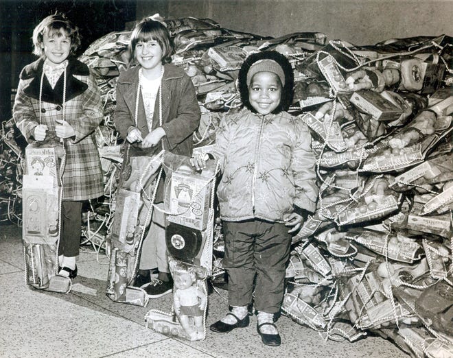 Journal Star photographer Jack Bradley took this photo of children receiving a stocking of toys at the Red Stocking party the paper held on Dec. 24, 1970. The newspaper traces its tradition of providing toys to needy children, with the community's help, to 1913.