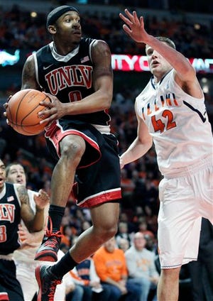 Nevada's Oscar Bellfield (0) looks to a pass against Illinois' Tyler Griffey (42) during the first half of an NCAA college basketball game in Chicago on Saturday, Dec. 17, 2011.