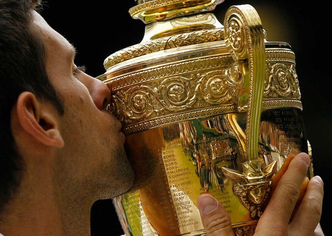 Serbia's Novak Djokovic kisses the trophy after defeating Spain's Rafael Nadal on July 3 in the men's singles final at Wimbledon.