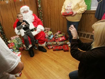 Tanya Finigan takes a photo of her son, Chase Skellenger, with Santa at the Franklin-Sussex Head Start holiday party.