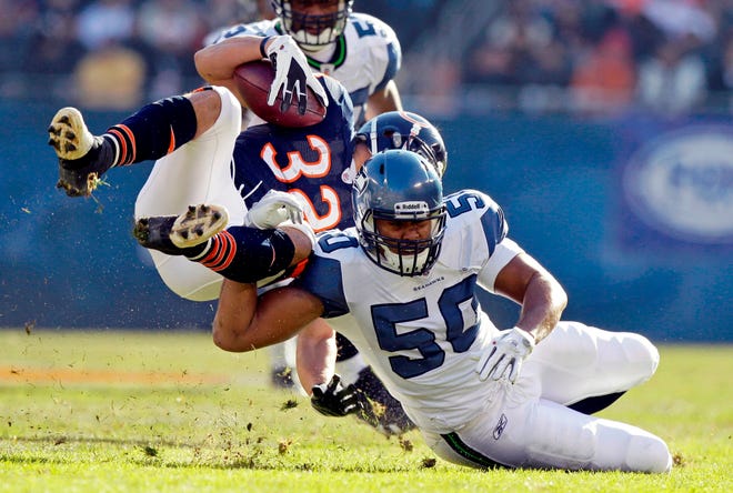 Chicago Bears running back Kahlil Bell (32) is tackled by Seattle Seahawks linebacker K.J. Wright in the first half in Chicago, Sunday, Dec. 18, 2011.