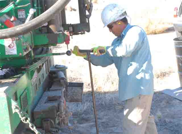 BC2 Environmental worker Geoff Sakioka hand drills the first 7 feet of a water sampling well near Soapmine Road Friday. The water board sampled 20 groundwater areas in northern Barstow for perchlorate to determine the spread of the contamination.