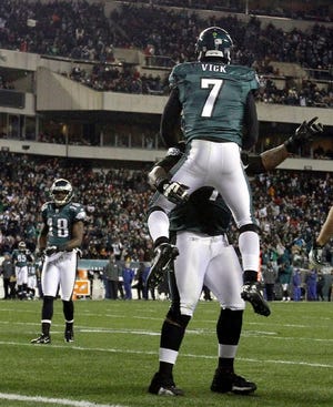 Philadelphia Eagles quarterback Michael Vick (7) celebrates his touchdown with tackle Jason Peters during the first half of the Eagles win over the New York Jets on Sunday.