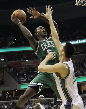 Boston’s Jeff Green shoots against Washington’s Yi Jianlian in April. Green will miss the entire season with a heart ailment.