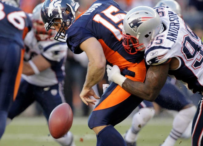 Denver Broncos quarterback Tim Tebow fumbles the ball as he is hit by New England Patriots defensive end Mark Anderson on Sunday in Denver. The Patriots won, 41-23.