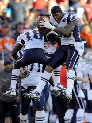 New England Patriots defensive end Mark Anderson (95) reacts with New England Patriots free safety Matthew Slater (18) after recovering a fumble by Denver Broncos quarterback Tim Tebow (15) in the second quarter of an NFL football game, Sunday, Dec. 18, 2011, in Denver. (AP Photo/Jack Dempsey)