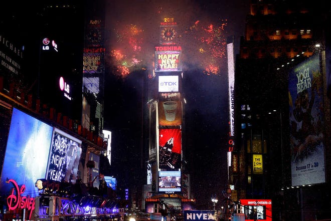 FILE-  This Jan. 1, 2011 file photo shows fireworks as they erupt from a building to signal the New Year, 2011, in Times Square in New York. The bubbly, the ball, the midnight kiss. Not all single women want a ring on it, but do they want a date for New Year's Eve? (AP Photo/Seth Wenig, FILE)