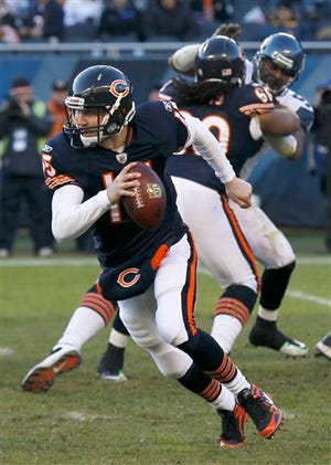 Chicago Bears quarterback Josh McCown (15) rolls out in the second half of an NFL football game against the Seattle Seahawks in Chicago on Sunday, Dec. 18, 2011. Starter Caleb Hanie struggled again filling in for the injured Jay Cutler in the team's loss to Seattle.