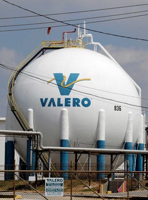 In this Sept. 16 file photo, a no-trespassing sign sits in front of a Valero Houston Refinery storage tank in Houston. The Texas environmental agency has rejected a request by Valero to get a large tax break at six refineries, exemptions that could have triggered refunds of up to $92 million that would have come out of the budgets of cash-strapped school districts and municipalities.