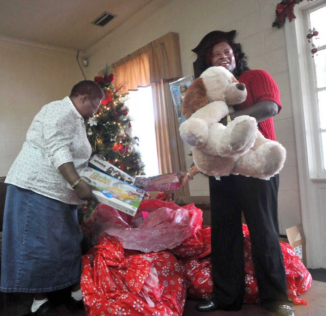 Barbara Simmions and Gena Taylor of Greenbriar look through the toys dropped off by firefighters.
