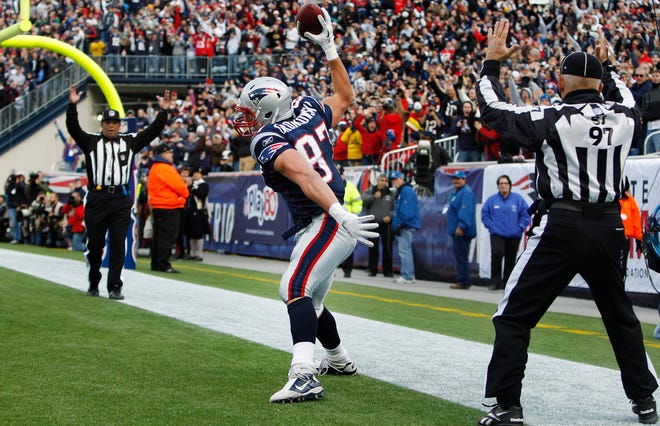 Patriots tight end Rob Gronkowski (87) spikes the ball as officials signal his touchdown during a game against the Colts in Foxboro. Gronkowski had three touchdowns in the Patriots' 31-24 win.