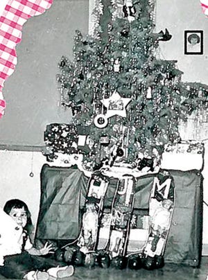 Mimi Gonzales sits in front of her family's Red Stocking gifts in 1953 in their Peoria home. The other stockings were gifts to Mimi's sister Hartemia and brother Octavio Jr.