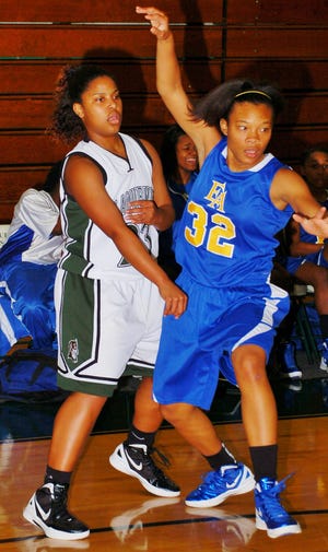 GETS PASS AWAY…Plaquemine High’s Kadijah Mims (left, 23) gets a pass away to a teammate despite pressure from an East Ascension Lady Spartan during a Lady Green Devil round ball victory last week.