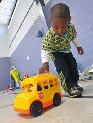 Richard Burkhart/Savannah Morning News Rasha Perry, 2, picks out his own toy during the annual Miracle on May Street, held at the West Broad Street YMCA.