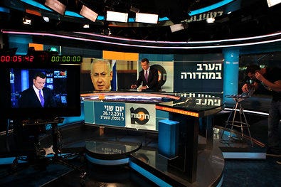 Jacob Eilon, evening news anchor of Channel 10 in Israel, preparing for a broadcast. The station is struggling to stay in business.