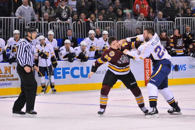 Peoria Rivermen enforcer Anthony Peluso drops Chicago Wolves heavyweight Matt Clackson during their first-period bout in Peoria's 4-3 sudden-death overtime loss on Dec. 26, 2011 at Carver Arena