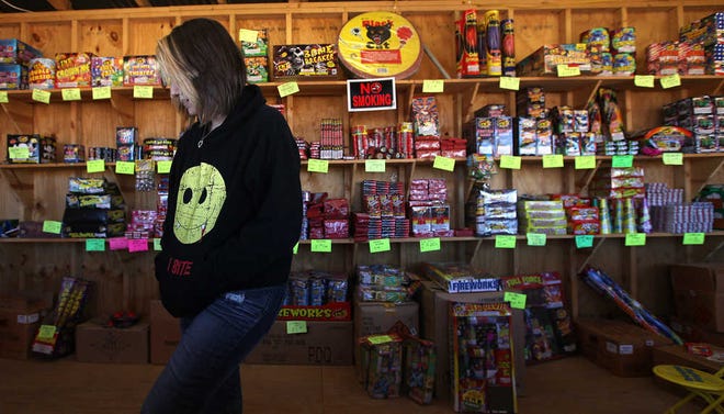Katie Toupin tends to Pop's Fireworks stand on Tuesday in Lubbock. Vendors say sales have been slow so far since they started on Monday.