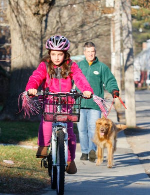 John Jardine and his daughter Anna, 10, take advantage of the sunny afternoon in Franklin yesterday. With them is their dog, Charlie.