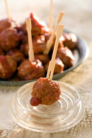Cranberry chipotle meatballs are a great holiday entertaining food. They are homey, well-loved and easy to do ahead of time.  (AP Photo/Matthew Mead)