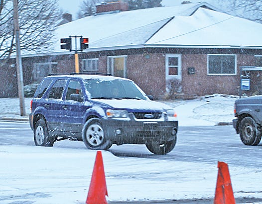 Slippery roads contributed to numerous accidents and even more close calls on Tuesday after a cold front rolled across the Eastern Upper Peninsula. The intersection of Bingham and Spruce, like many others throughout the area, was covered in ice making it difficult for motorists to stop. This particular SUV, according to eye witness accounts, managed to avoid a collision, but did wind up hopping the curb before control was regained.