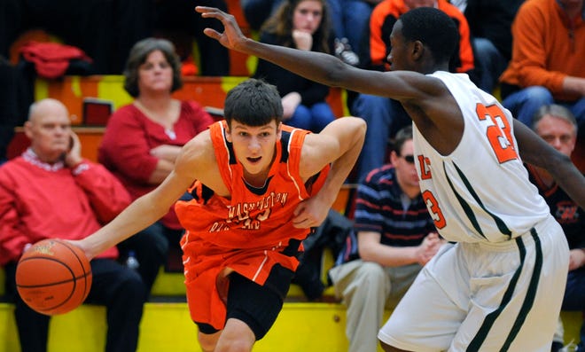 Cade Jackson drives the ball as Deontre Brown of Plainfield East defends.