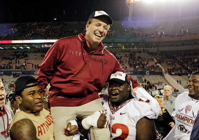 Florida State players carry head coach Jimbo Fisher off the field after they defeated Notre Dame 18-14 in the Champs Sports Bowl on Thursday in Orlando, Fla.