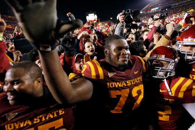 In this Nov. 18 file photo, Iowa State offensive lineman Kelechi Osemele celebrates with teammates and fans after Iowa State's 37-31 win in double overtime over Oklahoma State in Ames, Iowa. Iowa State became bowl eligible with the win, and will face Rutgers in the Pinstripe Bowl today.