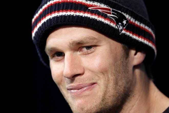 New England Patriots quarterback Tom Brady smiles at a reporters question during a media availability at the NFL football team's facility in Foxborough, Mass. Wednesday, Dec. 28, 2011. (AP Photo/Winslow Townson)