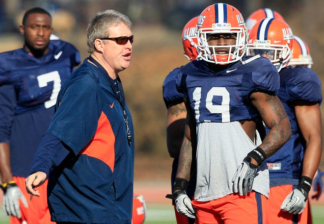 Illinois interim head coach Vic Koenning (left) talks with defensive back Jack Ramsey (19) during practice for Saturday's Fight Hunger Bowl college football game against UCLA at Laney College in Oakland, Calif., Wednesday, Dec. 28, 2011.