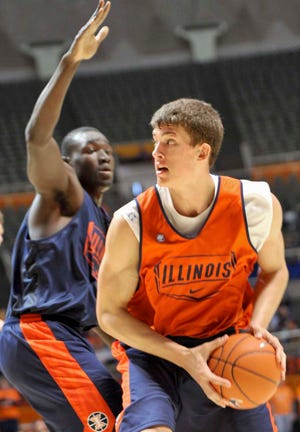 In this photo taken Oct. 23, 2011, Illinois center Meyers Leonard looks to shoot past Ibby Djimde during the team's annual Orange and Blue basketball scrimmage at Assembly Hall in Champaign, Ill. Illinois will have to lean heavily on Leonard this year, who said his role will be to "be a beast."