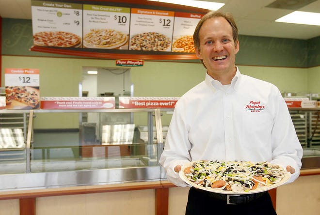 Ken Calwell, chief executive officer and board of directors member of Papa Murphy's International, shows off a take-and-bake pizza made at a Topeka store in November. Calwell, a Topeka native, has been selected as The Topeka Capital-Journal's 2011 Kansan of the Year.